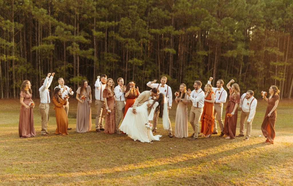 whole bridal party celebrating the bride and groom 