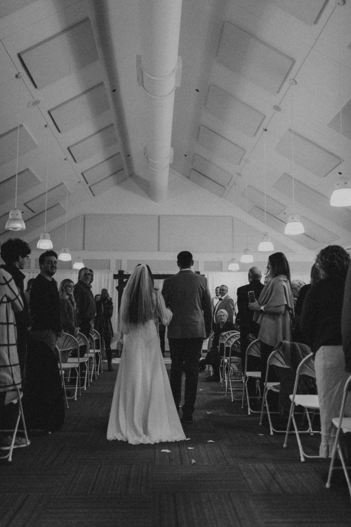 indoor ceremony, venue hall, boho, bride coming down the aisle